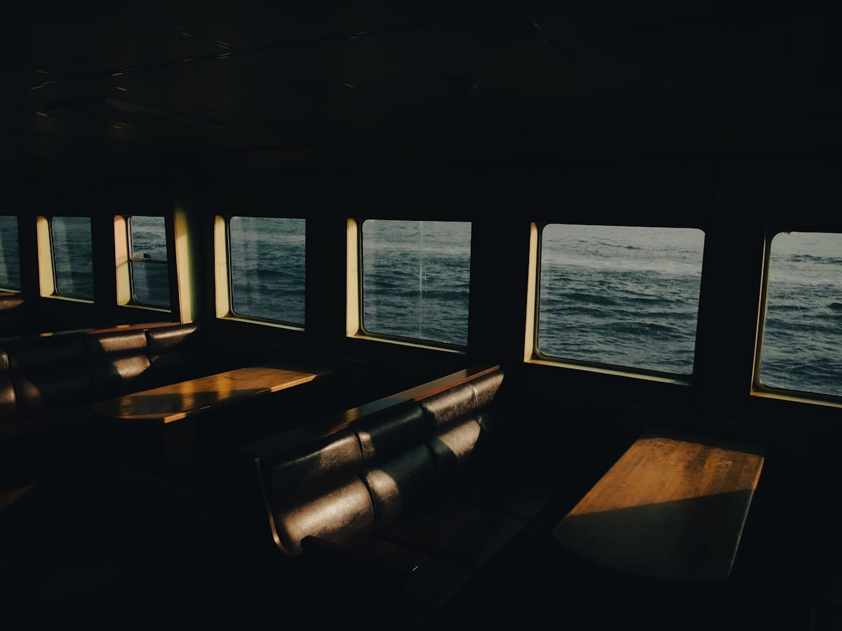 a row of benches sitting in front of a window
