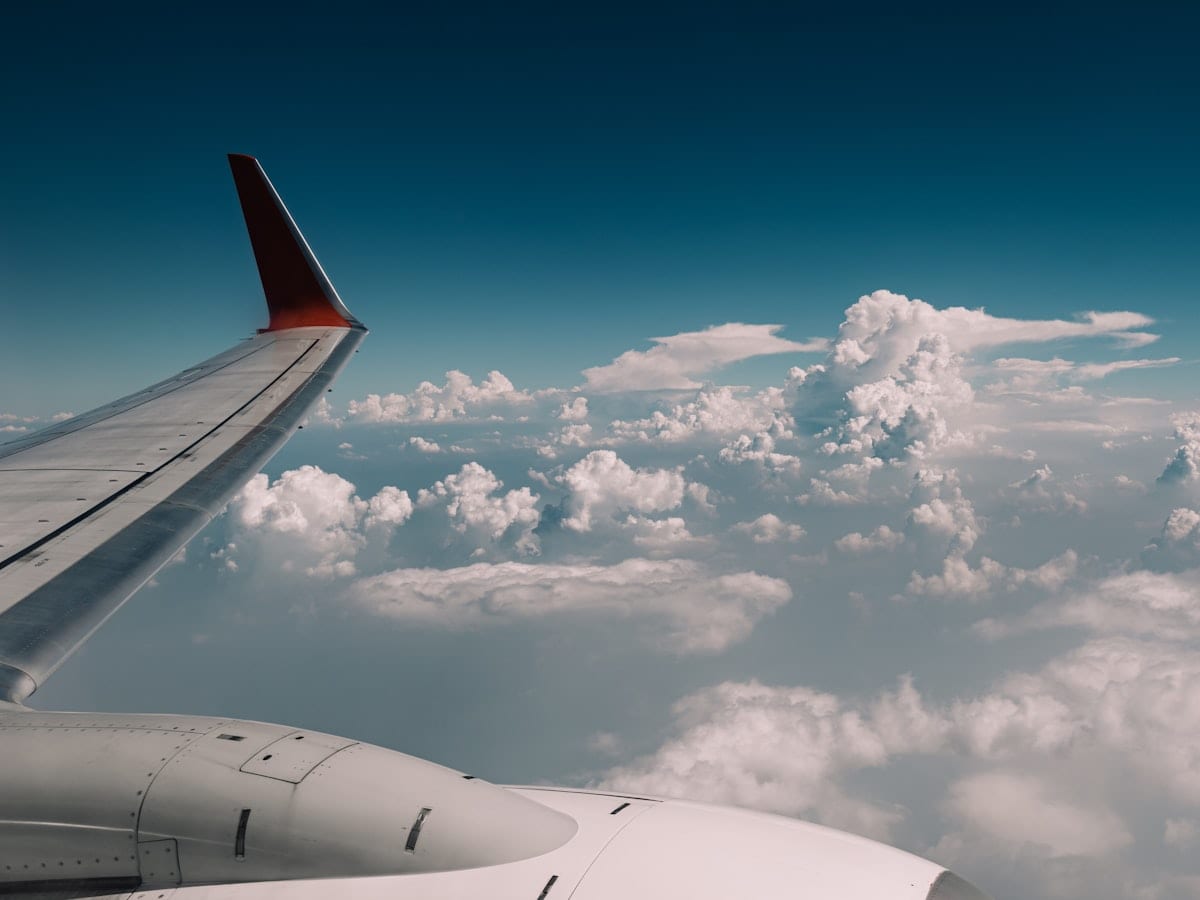 the wing of an airplane flying above the clouds