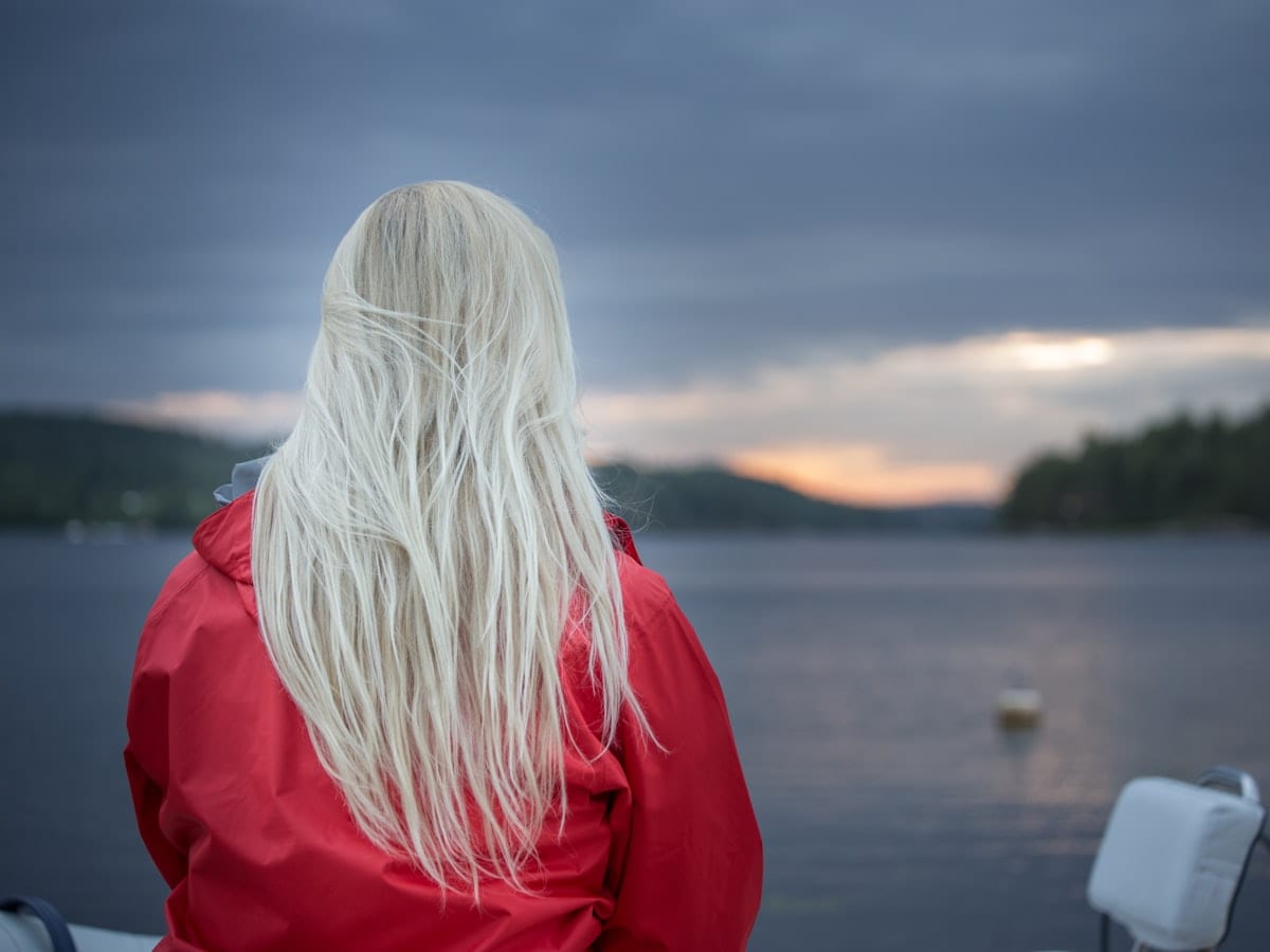 a woman with long white hair sitting on a boat