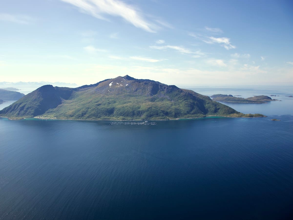a body of water with a mountain in the background