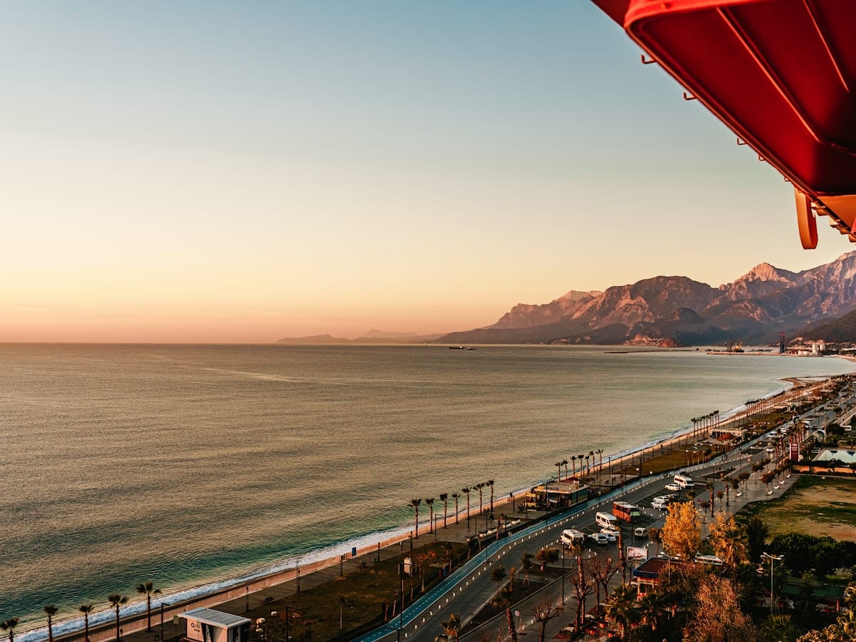 a view of the ocean and mountains from a balcony