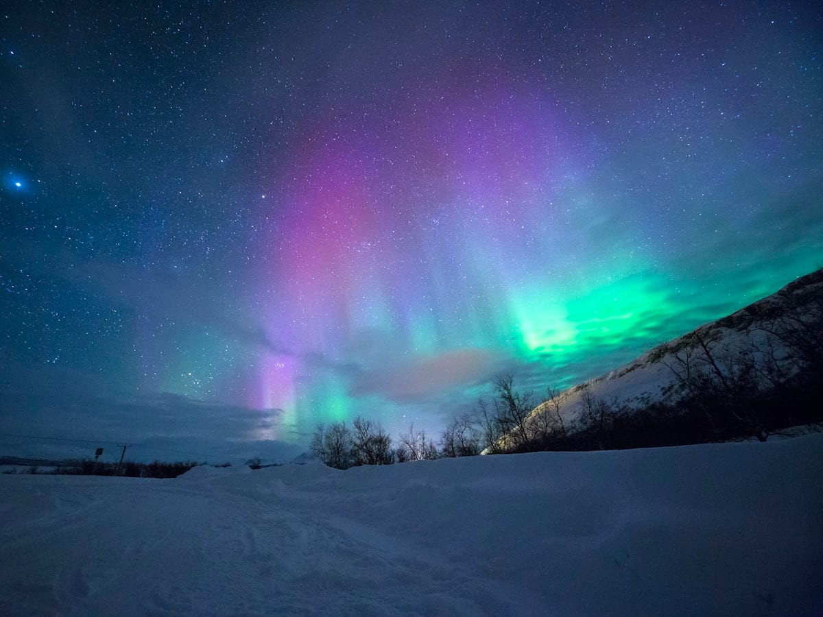 northern lights over snow-capped mountian