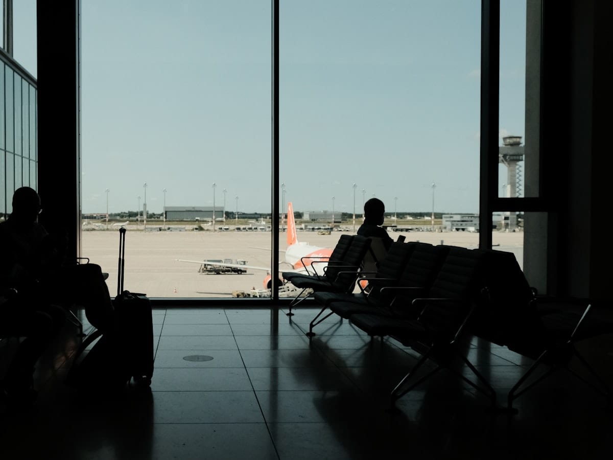 silhouette of man sitting on chair near window