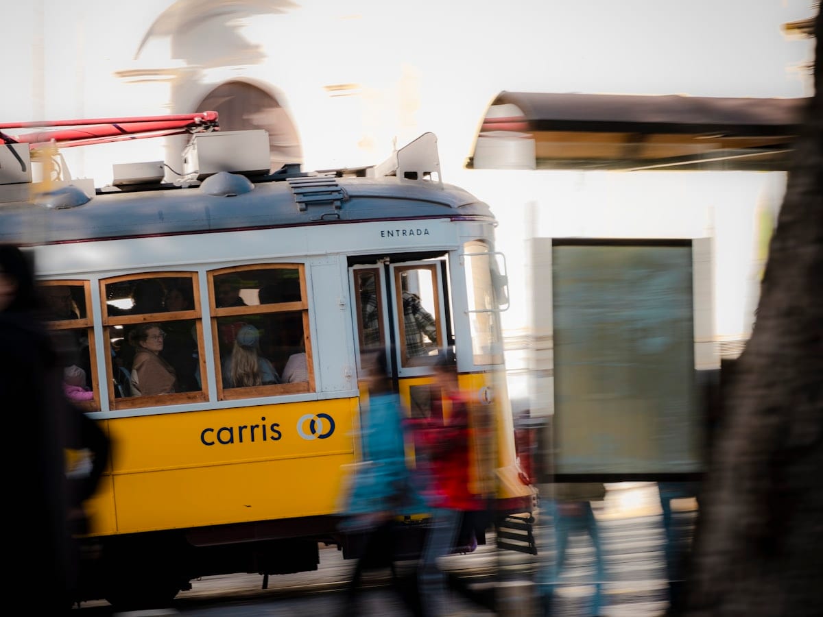 A yellow and blue trolly on a city street