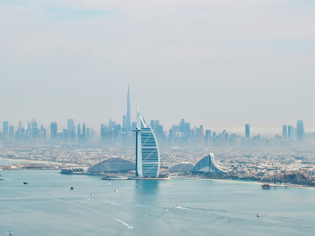 a large body of water with a city in the background