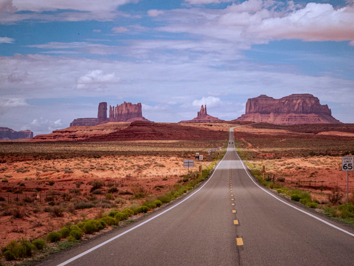 A long straight road in the middle of the desert