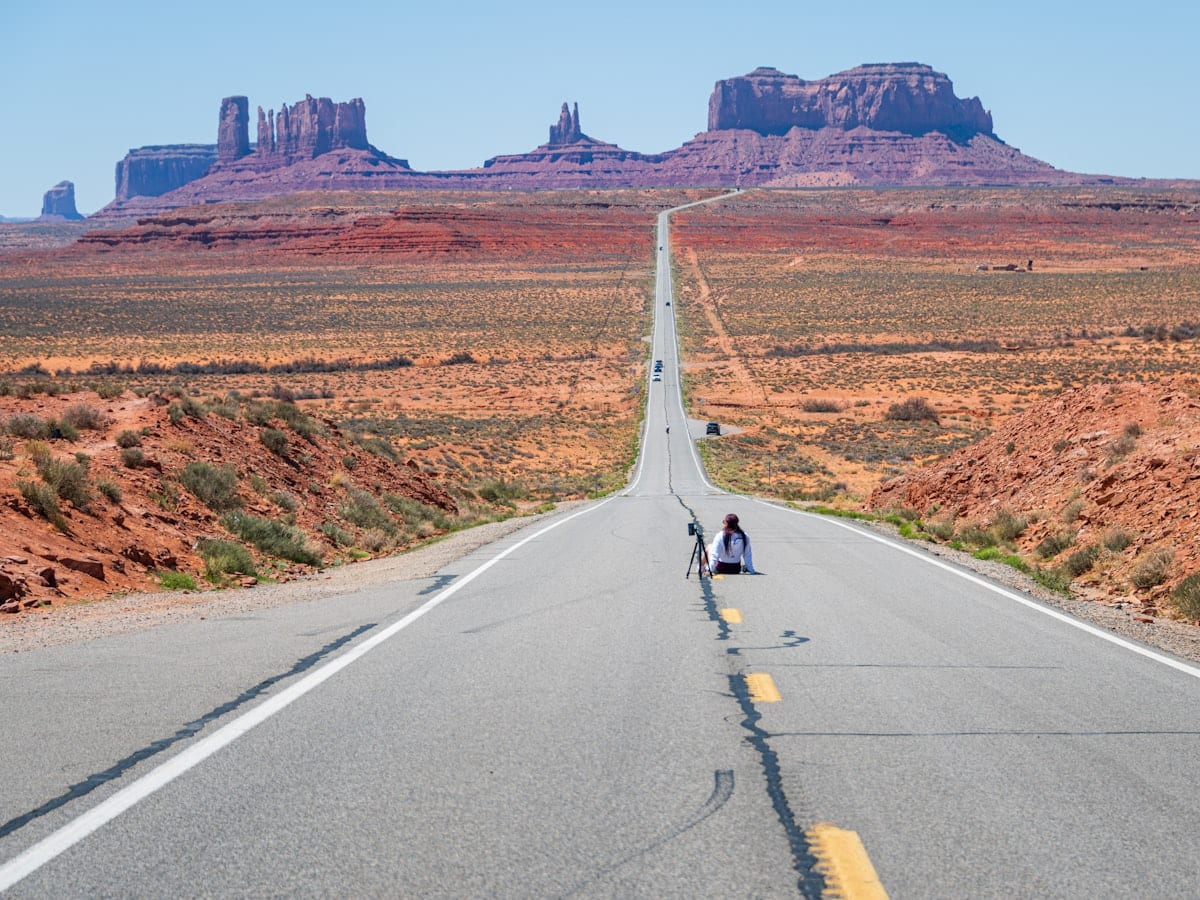 a couple of people that are sitting on a road