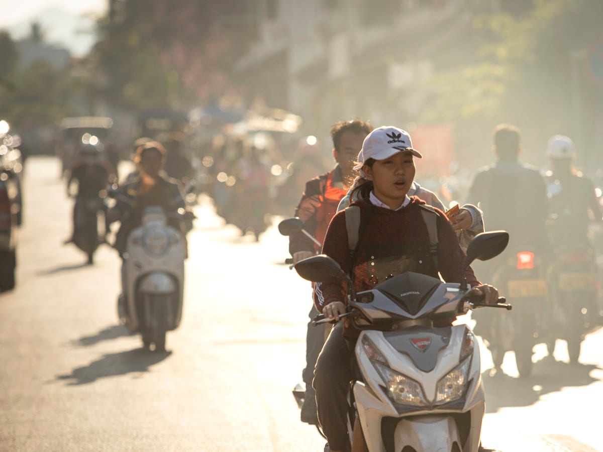 A group of people riding motorcycles down a street