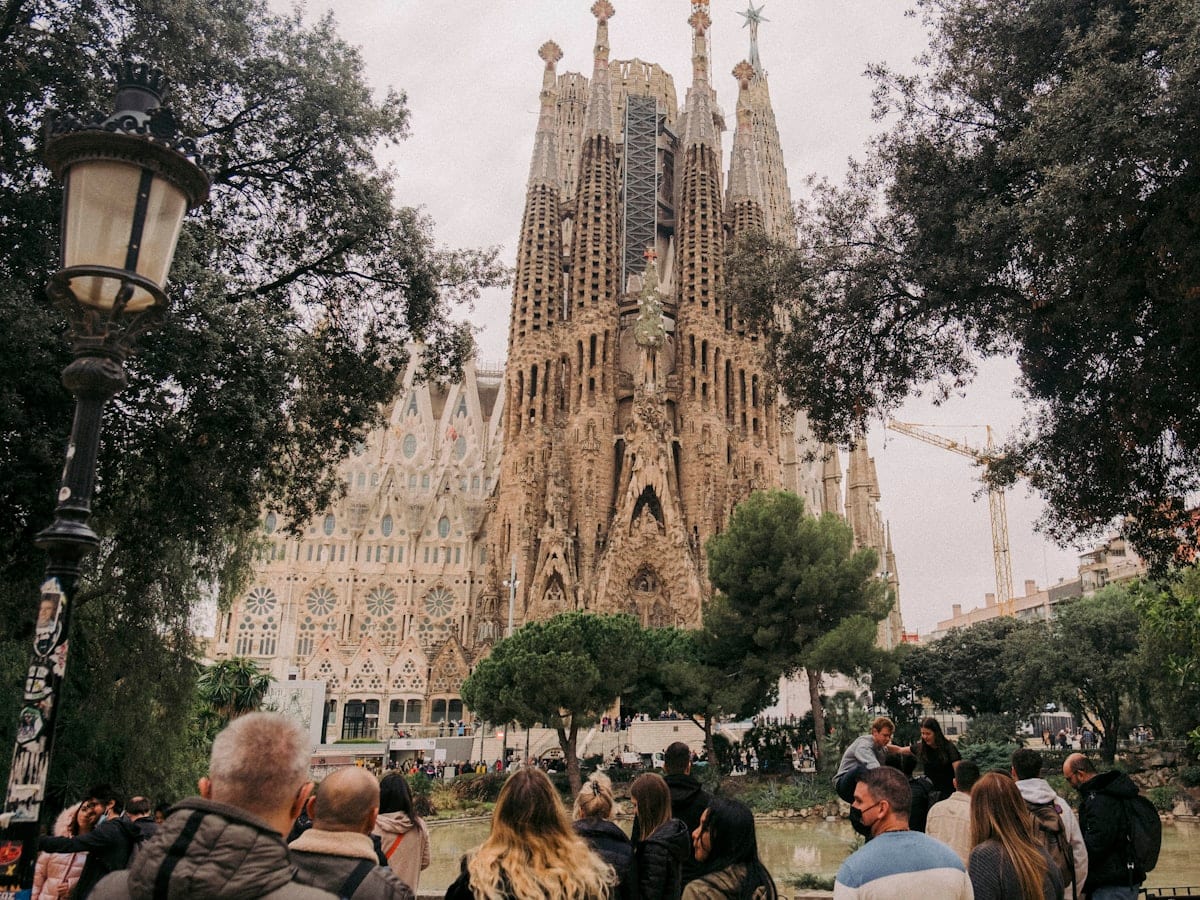 a crowd of people walking in front of a castle
