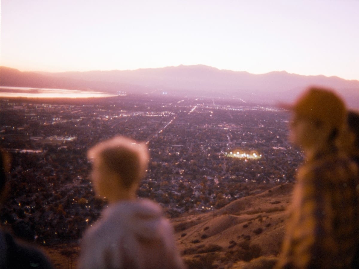 Children watch the city lights at dusk