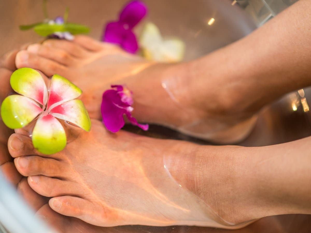 person's feet with flowers