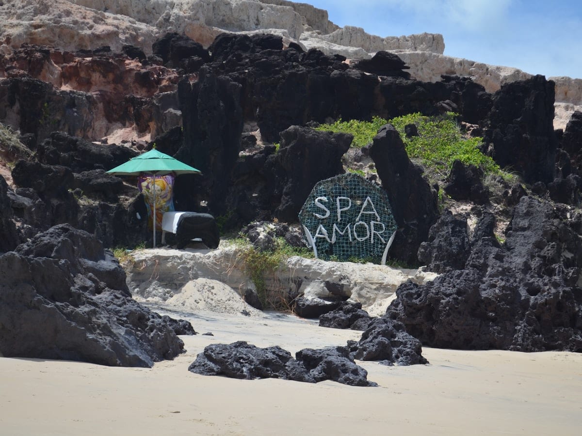Sign for spa amor on a rocky beach