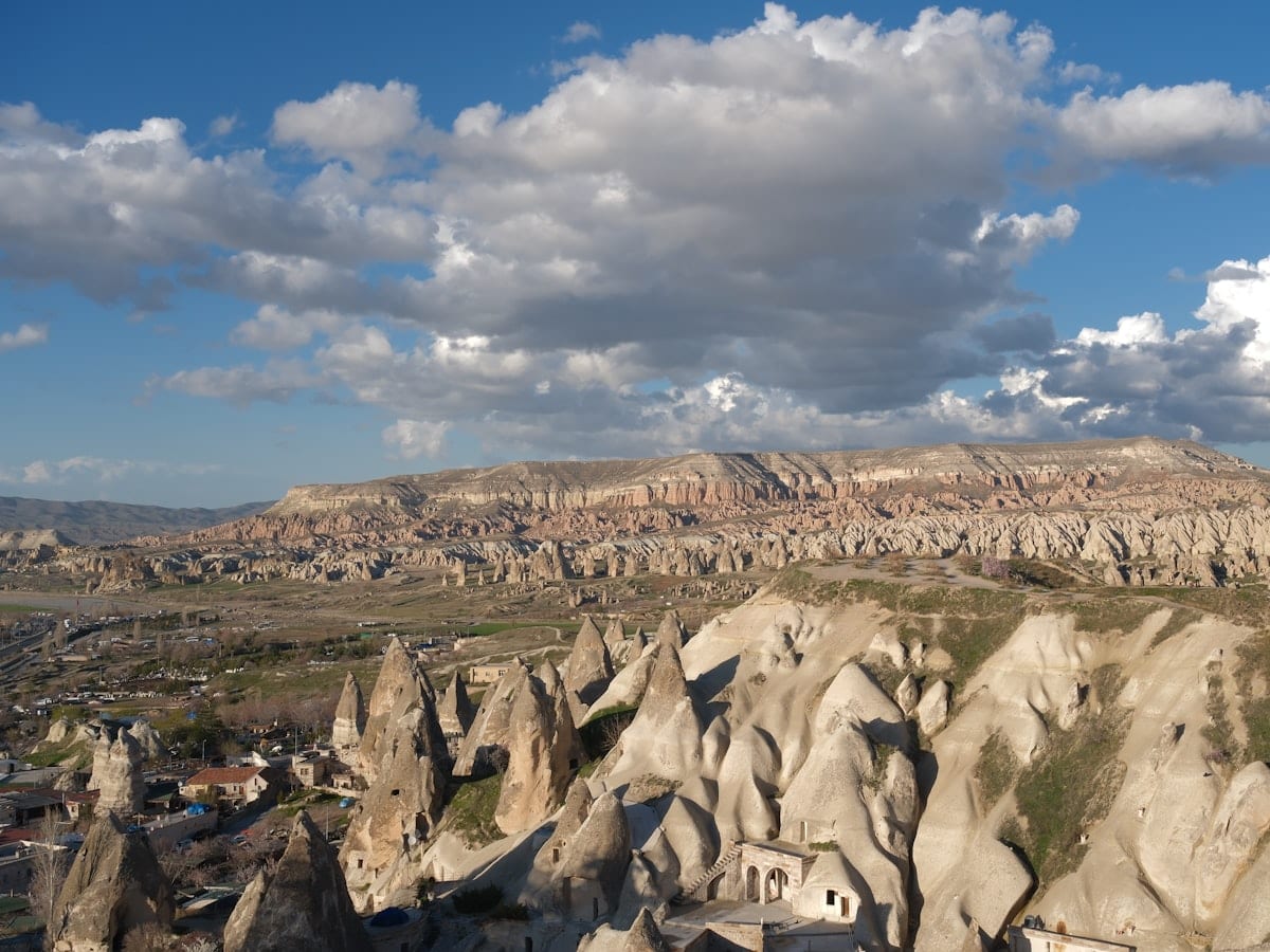 Cappadocia's distinctive rock formations and valley under clouds.