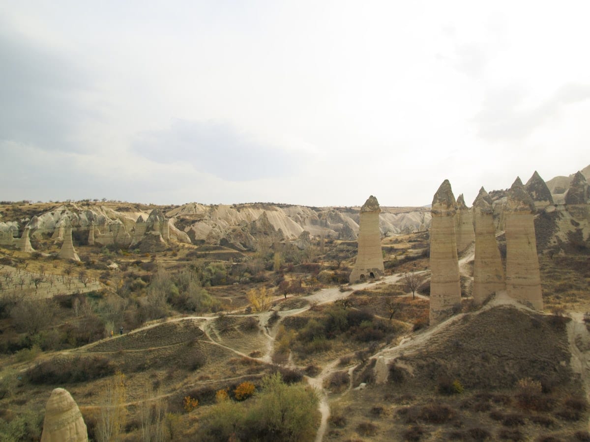 Unique rock formations in a dry, hilly landscape.