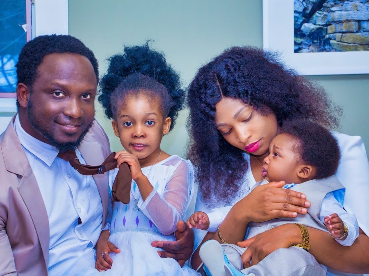 a man, woman, and child are posing for a picture